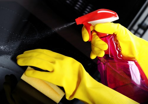 Cleaner wearing PPE while working with cleaning chemicals